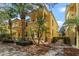 Beautiful yellow townhome with manicured landscaping, a brick walkway, and sunny skies at 11846 Nautica Dr, Orlando, FL 32827