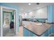 Well-lit kitchen with white cabinets, stainless steel appliances, and tiled floors at 11846 Nautica Dr, Orlando, FL 32827