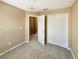 Neutral-toned bedroom with carpet, closet, and door to the hallway at 1260 Honey Blossom Dr, Orlando, FL 32824