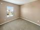 Neutral bedroom featuring soft carpet, one window, and minimal decor at 1260 Honey Blossom Dr, Orlando, FL 32824