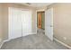 Bedroom features neutral carpeting, closet with bi-fold doors, and door to the hallway at 1260 Honey Blossom Dr, Orlando, FL 32824