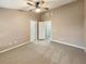 Bedroom featuring neutral carpeting, a ceiling fan, and multiple doors to other rooms at 1260 Honey Blossom Dr, Orlando, FL 32824