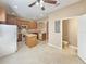 Well-lit kitchen features an island, white appliances, and direct access to a half-bathroom at 1260 Honey Blossom Dr, Orlando, FL 32824