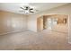 Inviting living room features neutral carpeting, ceiling fan, and an open archway to the kitchen at 1260 Honey Blossom Dr, Orlando, FL 32824