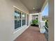 Charming front porch featuring brick flooring and a welcoming entrance at 1260 Honey Blossom Dr, Orlando, FL 32824