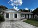 Charming single story home featuring a concrete driveway and light colored facade at 131 San Blas Ave, Kissimmee, FL 34743