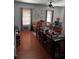 Open-concept living area with hardwood floors and multiple seating arrangements at 131 San Blas Ave, Kissimmee, FL 34743