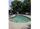 Relaxing outdoor pool surrounded by trees and foliage, ideal for outdoor enjoyment and recreation at 131 San Blas Ave, Kissimmee, FL 34743