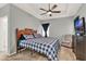 Bedroom with a ceiling fan and tray ceiling, and a chair at 1335 E 10Th St, Apopka, FL 32703