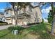 Exterior view of townhome featuring well-maintained landscaping and a two-car garage at 1335 E 10Th St, Apopka, FL 32703