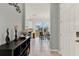 Hallway view of dining area with modern chandelier and natural light from backyard at 1335 E 10Th St, Apopka, FL 32703