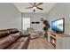 Inviting living room with a ceiling fan, carpeted floors, a sofa, and an electric fireplace at 1335 E 10Th St, Apopka, FL 32703