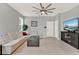 Inviting living room featuring a comfortable sofa, a modern ceiling fan, and a large flat-screen television at 1335 E 10Th St, Apopka, FL 32703