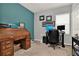 Well-organized home office featuring a rolltop desk, ample storage, and a comfortable workspace at 1335 E 10Th St, Apopka, FL 32703