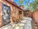 View of back of home featuring a stone patio with a chair and lush greenery at 136 Raintree Dr, Longwood, FL 32779