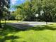 Outdoor basketball court with multiple hoops surrounded by lush green grass at 136 Raintree Dr, Longwood, FL 32779