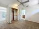 Bedroom with a ceiling fan, carpet flooring and folding door closet at 136 Raintree Dr, Longwood, FL 32779