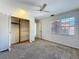 Well-lit bedroom with a ceiling fan, closet, carpeted floor and sun-filled windows at 136 Raintree Dr, Longwood, FL 32779