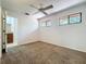 Carpeted bedroom with two windows and bathroom access at 136 Raintree Dr, Longwood, FL 32779