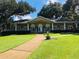 Community clubhouse featuring a covered porch, manicured lawn, and sidewalk at 136 Raintree Dr, Longwood, FL 32779