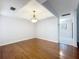 Open-concept dining room featuring hardwood flooring and a decorative light fixture at 136 Raintree Dr, Longwood, FL 32779