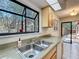 Kitchen sink view looking out to a large window with natural light at 136 Raintree Dr, Longwood, FL 32779