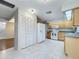 Spacious kitchen with white appliances, wood cabinets, and tile flooring at 136 Raintree Dr, Longwood, FL 32779