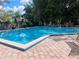 Community pool with chairs and tables surrounding the pool and deck at 136 Raintree Dr, Longwood, FL 32779