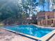 Community pool with chairs and tables surrounding the deck at 136 Raintree Dr, Longwood, FL 32779