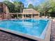 Community pool with chairs and tables surrounding the pool and deck at 136 Raintree Dr, Longwood, FL 32779