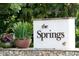 Community welcome sign with lovely landscaping and colorful flowers at 136 Raintree Dr, Longwood, FL 32779