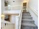 Bright and airy staircase with carpeted steps and white railing at 136 Raintree Dr, Longwood, FL 32779