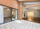 Sunroom with tile flooring overlooking living room with stone fireplace at 136 Raintree Dr, Longwood, FL 32779