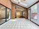 Sunroom with tiled floor leading to living room with a stone fireplace at 136 Raintree Dr, Longwood, FL 32779