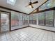 Bright sunroom featuring tile floors, a ceiling fan, skylight, and large windows with natural light at 136 Raintree Dr, Longwood, FL 32779