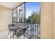 Screened balcony area featuring an outdoor table set, and community view beyond at 1371 Tuscan Terrace # 3203, Davenport, FL 33896