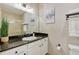 Bright bathroom with granite countertop, white cabinets, and tiled shower at 1371 Tuscan Terrace # 3203, Davenport, FL 33896