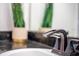 Close-up of a bathroom sink with dark hardware, granite countertop and a green plant at 1371 Tuscan Terrace # 3203, Davenport, FL 33896