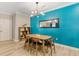 Bright dining room features wood table, modern light fixture and textured accent wall at 1371 Tuscan Terrace # 3203, Davenport, FL 33896