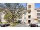 Beautiful exterior shot of a four-story building showing balconies and manicured landscaping at 1371 Tuscan Terrace # 3203, Davenport, FL 33896