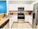 Bright and airy kitchen featuring stainless steel appliances and white cabinets at 1371 Tuscan Terrace # 3203, Davenport, FL 33896