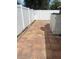 A view of the backyard patio and white fencing with trees in the background at 1422 Spalding Rd, Winter Springs, FL 32708