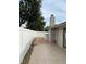 A view of the backyard patio and white fencing with trees in the background at 1422 Spalding Rd, Winter Springs, FL 32708