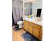 Bathroom features a wood vanity, white countertop, mirror and ceramic tile flooring at 1422 Spalding Rd, Winter Springs, FL 32708