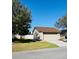 Exterior shot of a well-maintained single Gathering home with a two-car garage and a lush green lawn at 1422 Spalding Rd, Winter Springs, FL 32708