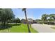 Exterior shot with a well-manicured lawn, leading to a community building, and a tennis court at 1422 Spalding Rd, Winter Springs, FL 32708