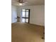 View of the carpeted living room with sliding glass doors to the lanai at 1422 Spalding Rd, Winter Springs, FL 32708