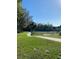 Scenic view of a walking path with lush green surroundings and a distant tennis court at 1422 Spalding Rd, Winter Springs, FL 32708