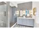 Modern bathroom featuring a glass shower and double vanity at 1427 Fairview Cir, Reunion, FL 34747