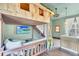 Themed bedroom with a custom treehouse bunk bed, swing, and built in kitchenette at 1427 Fairview Cir, Reunion, FL 34747